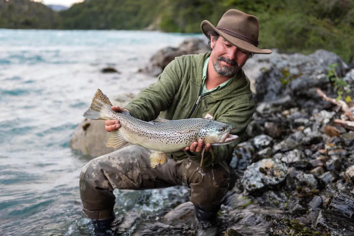 Rio Baker Guide Rafael holds a healthy brown trout caught below the rapids of the Rio Baker