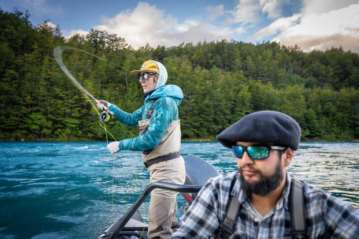 Nico Vargas positions the boat as Christine Marozick lines up a cast on the Río Baker.