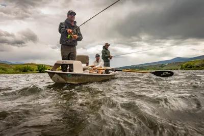 Anglers fish from a McKenzie River-style drift boat on the Madison River near Ennis, Montana.