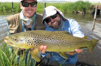 Happy angler with a big brown